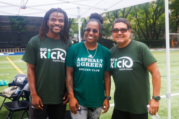 Coach Kas, left, pictured alongside parents from Asphalt Green's Community Soccer League. 