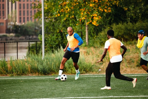 Wayne Montague, left,  dribbling during the adult soccer league practice