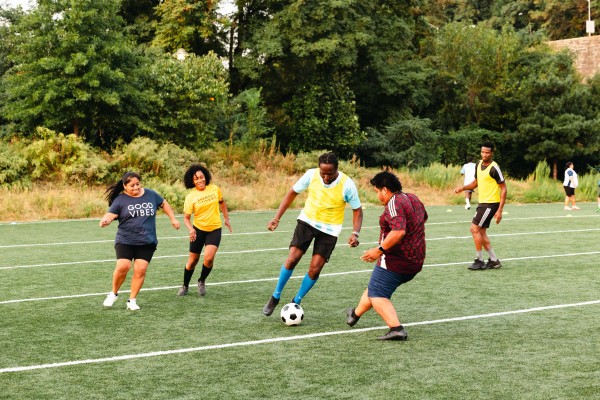 Kimberly, pictured in yellow, takes the field in an adult league scrimmage